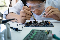 Technician checks the electronic device. Printed circuit board for the robot.